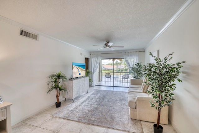 tiled living room with ceiling fan, ornamental molding, and a textured ceiling