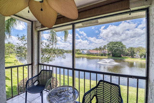 sunroom / solarium featuring a water view