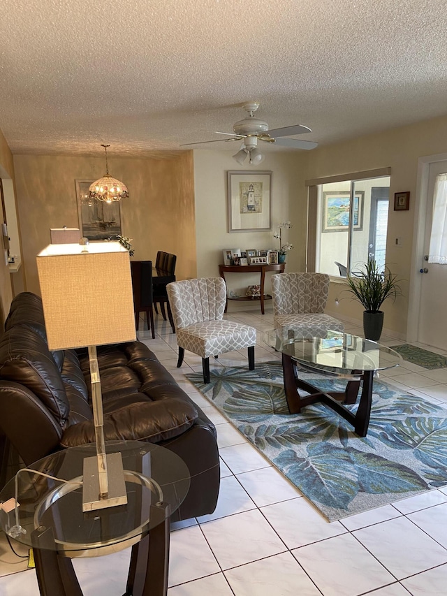 3560 Pine Tree Ct Unit A-2, Greenacres, FL 33463 - living room featuring light tile patterned floors, ceiling fan with notable chandelier, and a textured ceiling