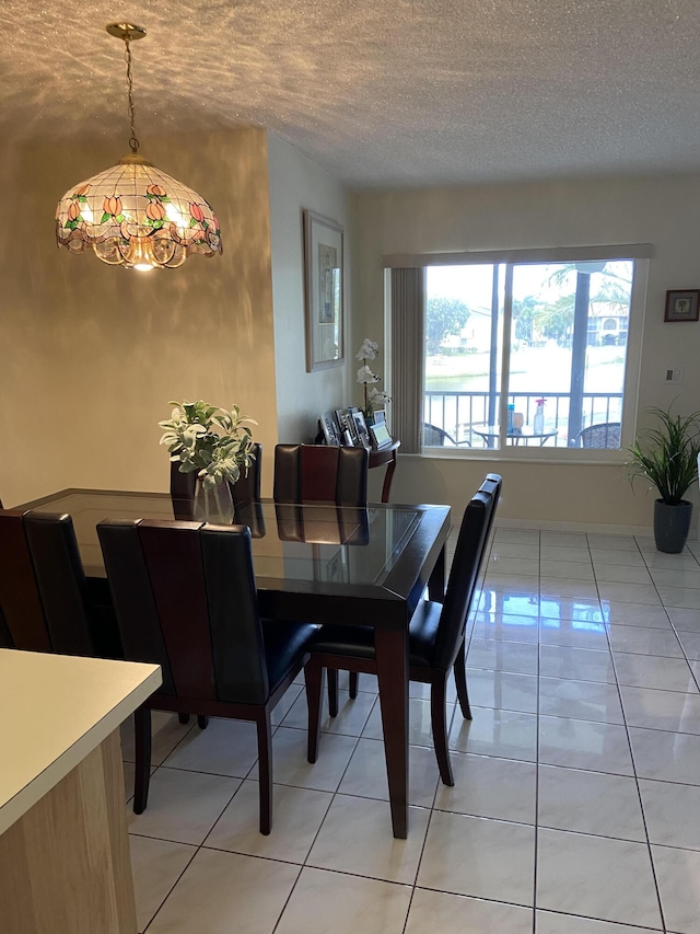3560 Pine Tree Ct Unit A-2, Greenacres, FL 33463 - dining area with light tile patterned floors, an inviting chandelier, and a textured ceiling