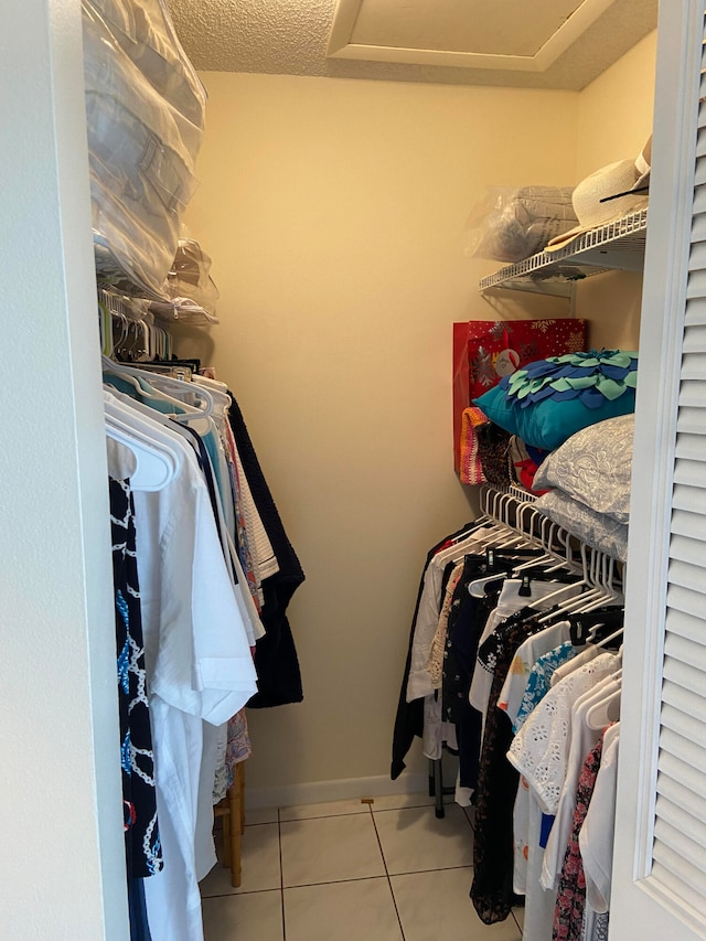 spacious closet with light tile patterned flooring