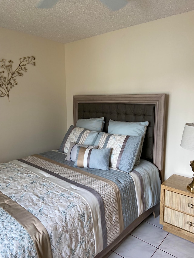 tiled bedroom featuring a textured ceiling