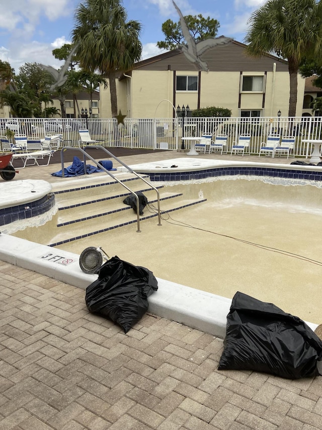 3560 Pine Tree Ct Unit A-2, Greenacres, FL 33463 - view of patio with fence and a community pool