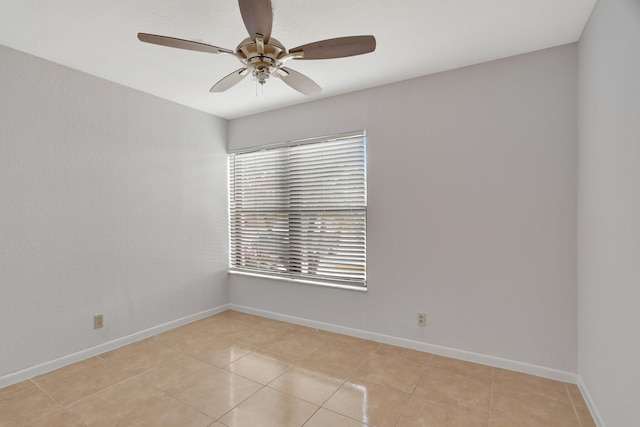 unfurnished room with ceiling fan and light tile flooring