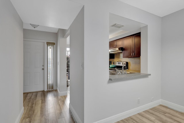 foyer with sink and light wood-type flooring