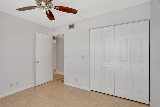 unfurnished bedroom with a closet, ceiling fan, and light tile floors