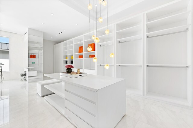 bedroom with a tray ceiling, access to exterior, a notable chandelier, and light wood-type flooring