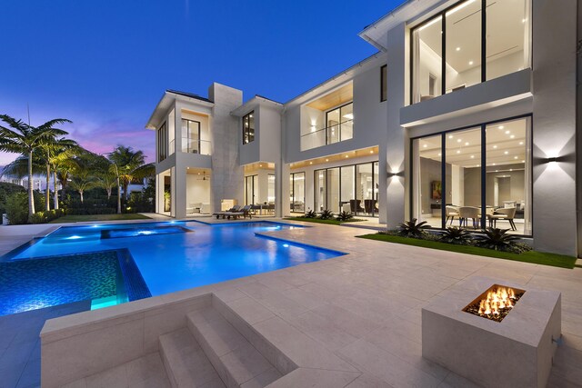 modern home featuring a balcony and a garage