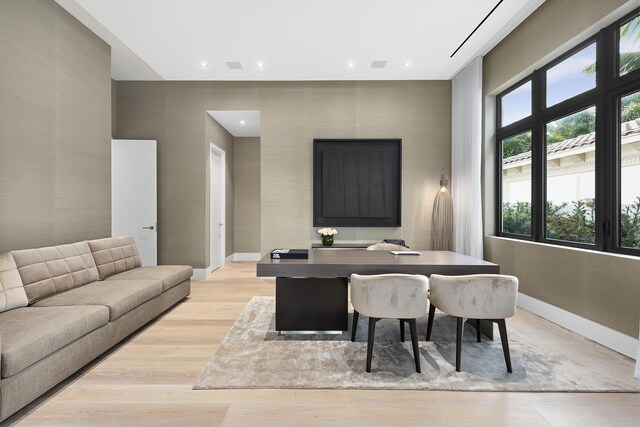 living room with beamed ceiling and light hardwood / wood-style floors