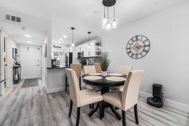 dining room with light hardwood / wood-style flooring