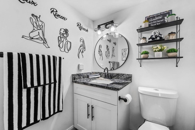 bathroom featuring toilet and large vanity