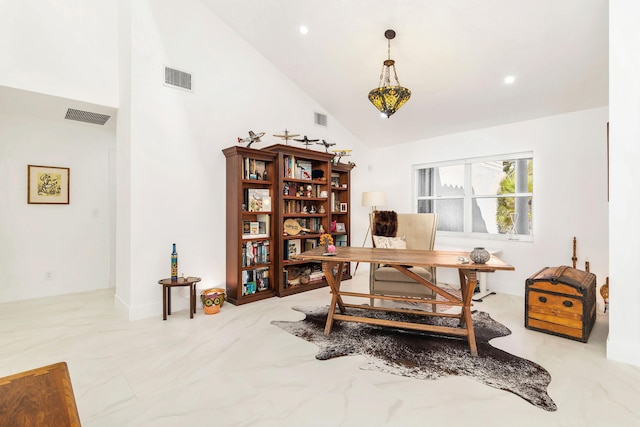 office area with high vaulted ceiling