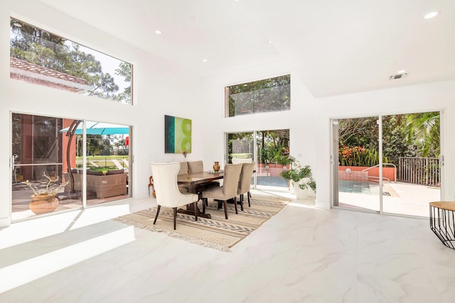 dining space with a towering ceiling