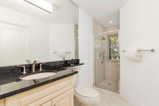 bathroom with a shower with shower door, toilet, and vanity