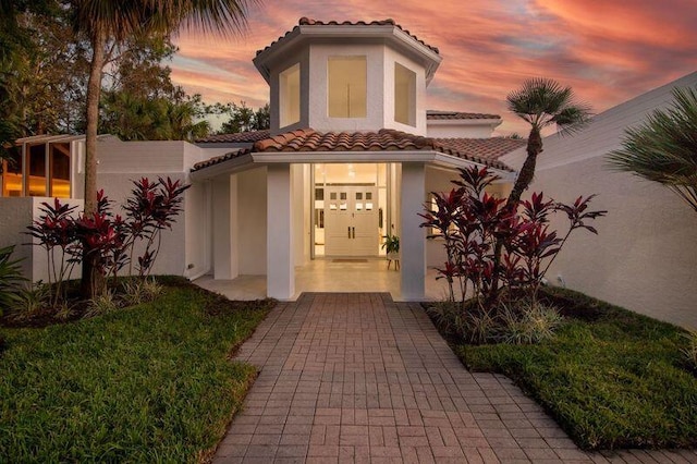 view of exterior entry at dusk