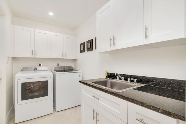 laundry area with cabinets, independent washer and dryer, and sink