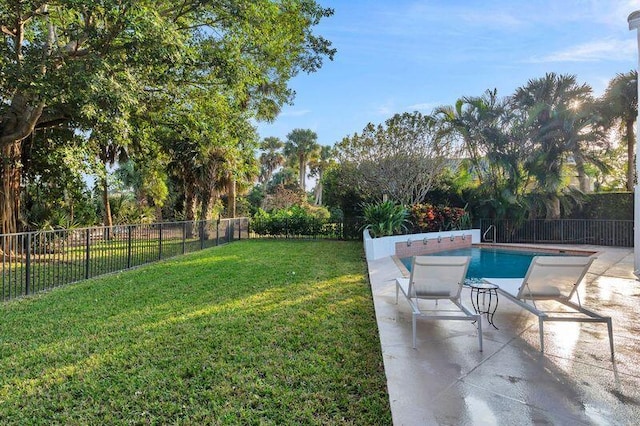 view of yard featuring a fenced in pool and a patio