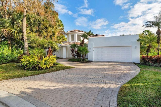 mediterranean / spanish-style house with a garage