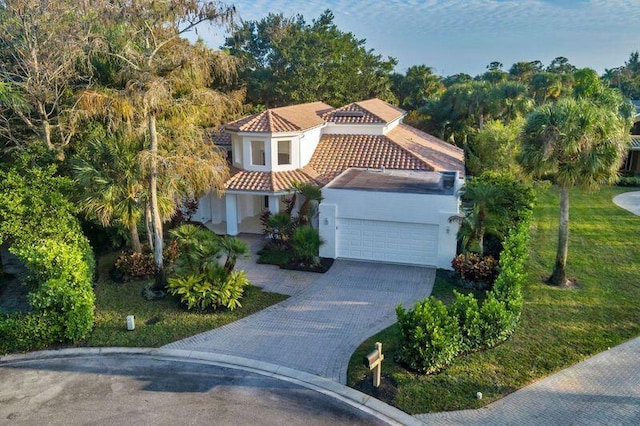 mediterranean / spanish-style home with a garage