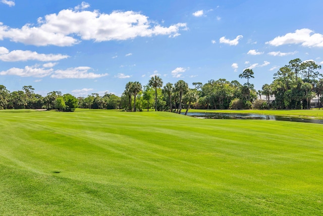 surrounding community featuring a water view and a yard