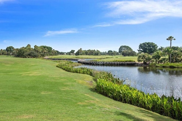 view of community featuring a yard and a water view