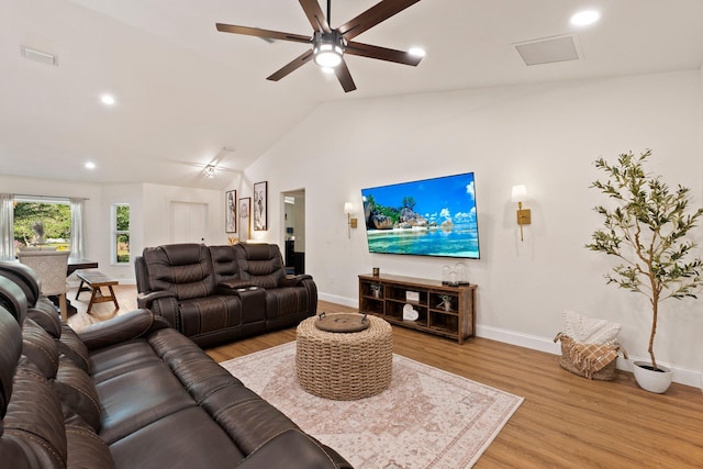 living room featuring lofted ceiling, ceiling fan, and light wood-type flooring