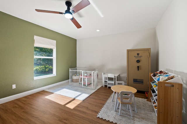 game room with wood-type flooring and ceiling fan