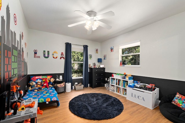 rec room with plenty of natural light, wood-type flooring, and ceiling fan