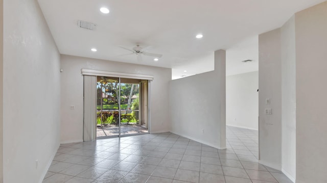 empty room with ceiling fan and light tile floors