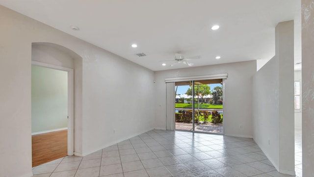 tiled empty room with ceiling fan