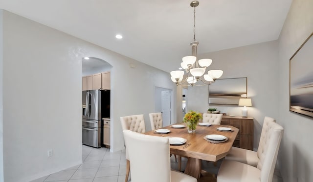 tiled dining room featuring a notable chandelier