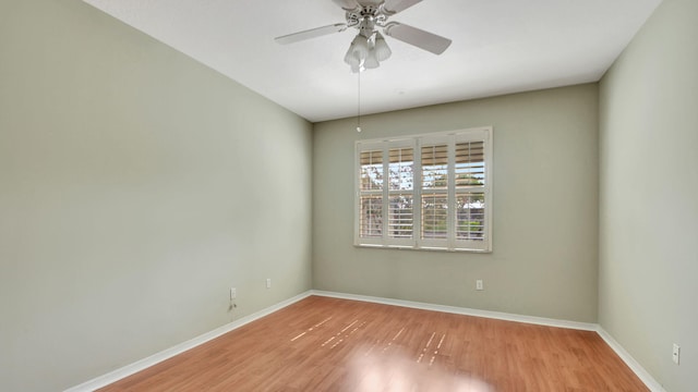 unfurnished room with ceiling fan and hardwood / wood-style flooring