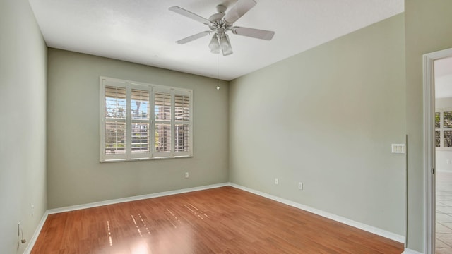 spare room featuring wood-type flooring and ceiling fan