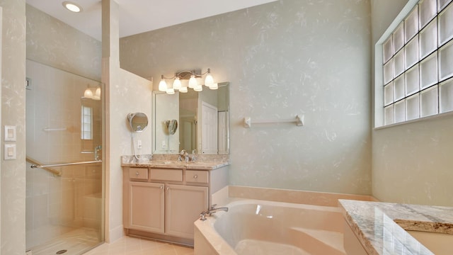 bathroom featuring tile flooring, separate shower and tub, and vanity