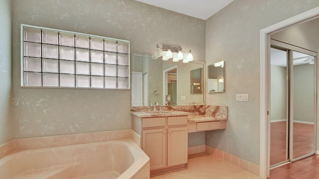 bathroom featuring vanity, hardwood / wood-style flooring, and a bathtub