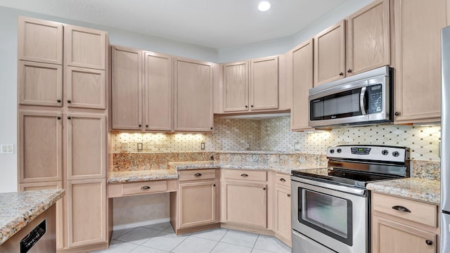 kitchen featuring backsplash, appliances with stainless steel finishes, light tile floors, and light brown cabinets