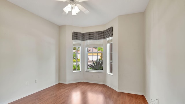 spare room with ceiling fan and wood-type flooring