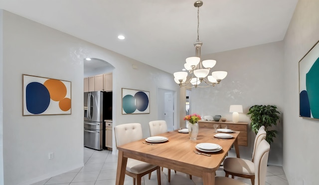 dining area with an inviting chandelier and light tile flooring