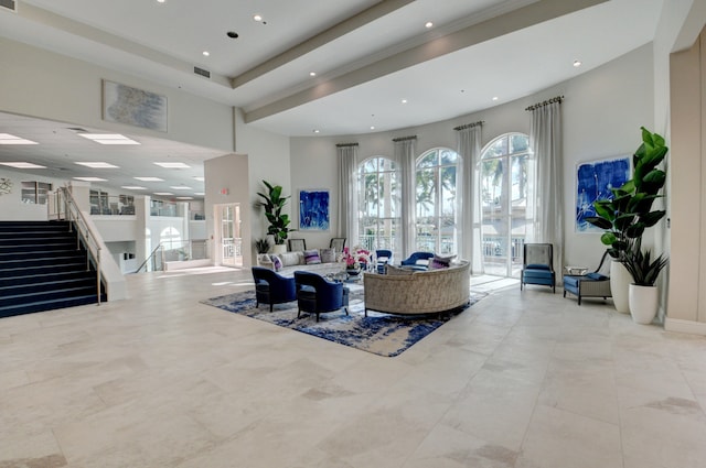 tiled living room with a tray ceiling and a high ceiling