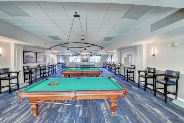 recreation room featuring dark colored carpet, billiards, and a drop ceiling