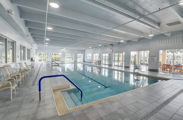 view of swimming pool featuring french doors