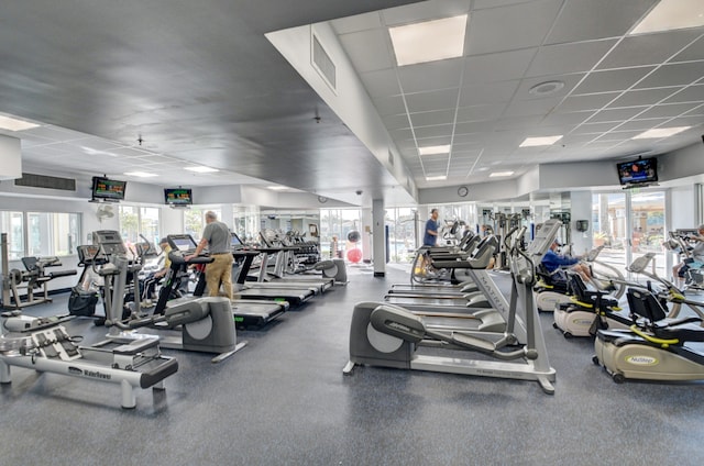 gym with a wealth of natural light and a paneled ceiling