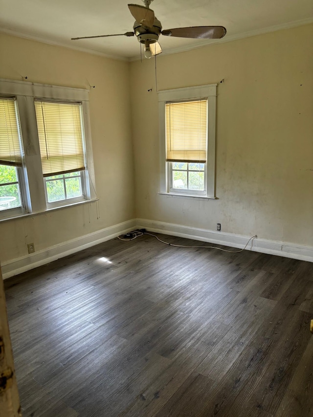 unfurnished room featuring ceiling fan, crown molding, and dark wood-type flooring