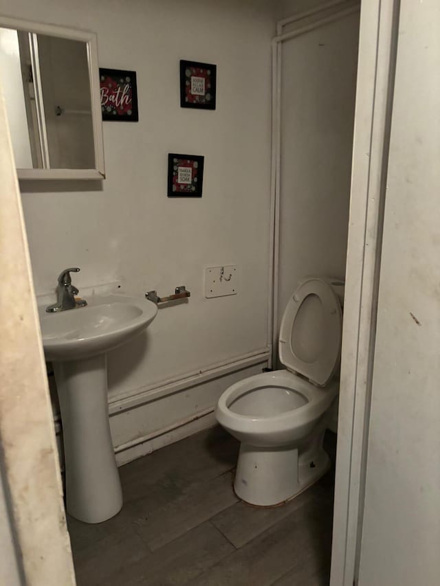 bathroom featuring toilet and hardwood / wood-style flooring