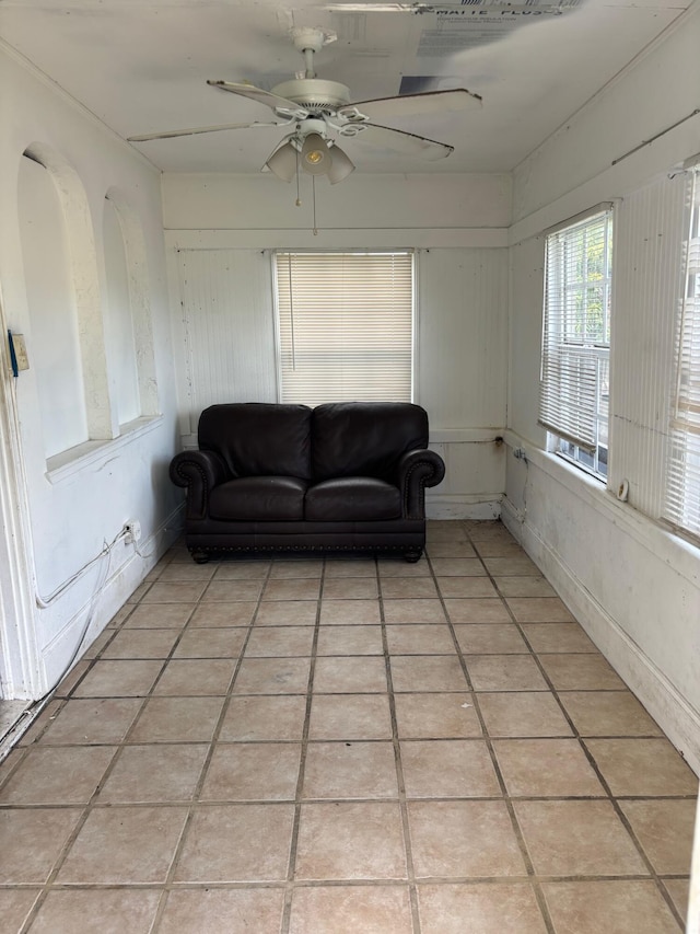 tiled living room with ceiling fan