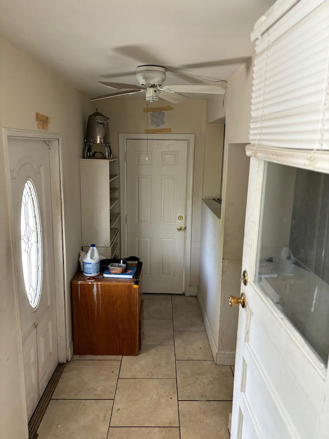 interior space featuring ceiling fan and light tile patterned floors