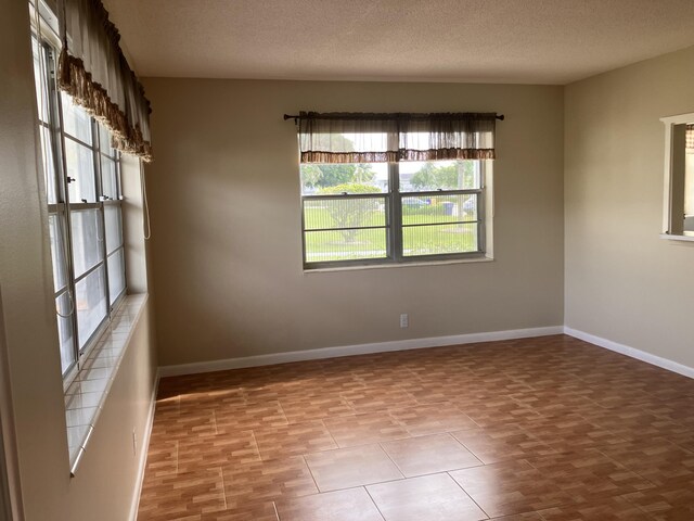226 Camden J, West Palm Beach, FL 33417 - unfurnished room with baseboards and a textured ceiling