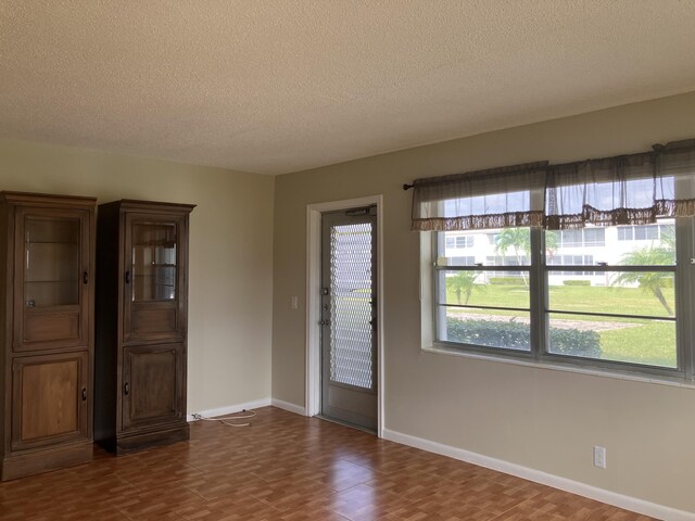 226 Camden J, West Palm Beach, FL 33417 - spare room with a textured ceiling, wood finished floors, and baseboards