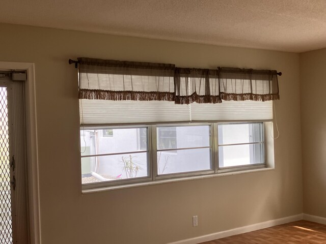 226 Camden J, West Palm Beach, FL 33417 - empty room featuring baseboards, a textured ceiling, and wood finished floors