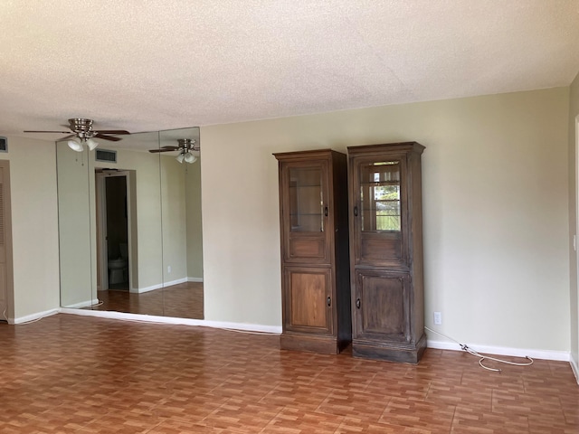 spare room featuring ceiling fan and a textured ceiling